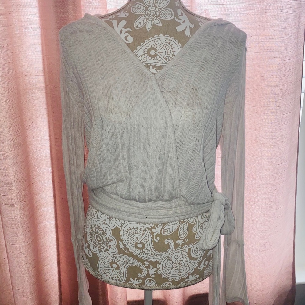 Cropped white top with tie on the side.